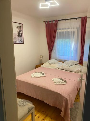 a bedroom with two beds with towels on them at Nefelejcs-el vendeghaz in Balatonmáriafürdő