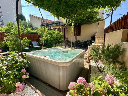 a hot tub in the middle of a garden at Antique Garden Villa in Split