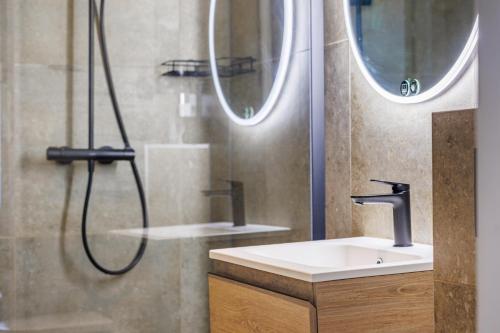 a bathroom with a shower and a sink at The Black Swan Hotel in Bruges