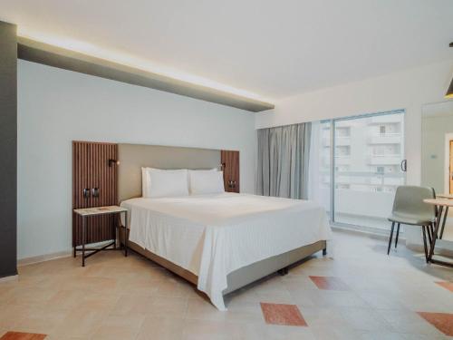 Ένα ή περισσότερα κρεβάτια σε δωμάτιο στο HS HOTSSON Hotel Acapulco