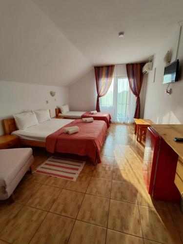 a hotel room with two beds and a couch at Pensiunea Orion in Costinesti