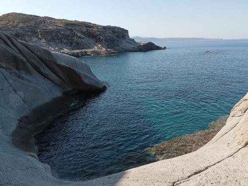 a large body of water next to a rocky shore at Aghinas in Bosa