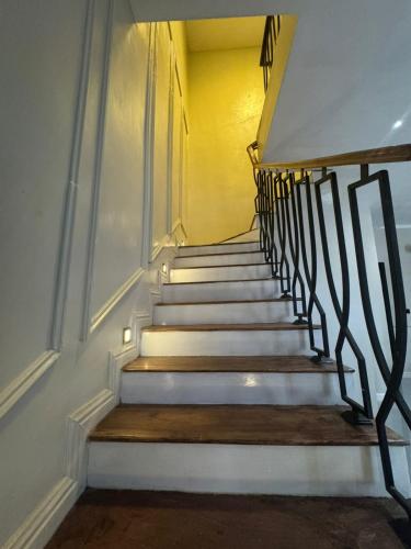 a stairway with white steps and a yellow wall at 4bedroom Stunning Terrace Apartment In Orchid Lekki in Lekki