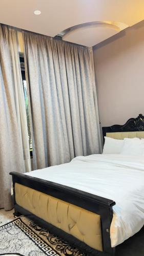 a bedroom with a bed and a large window at Silver Homes Empiror in Kampala
