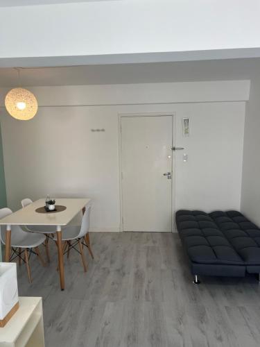 a living room with a couch and a table at Luminoso departamento en el centro de la ciudad in Mar del Plata