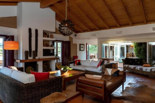 a living room with couches and a fireplace at Naturarte Campo - Duna Parque Group in São Luis