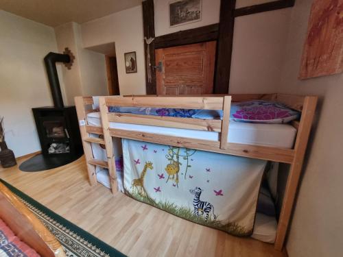 a bunk bed in a room with a bed in a room at Alpaka Ferienhof Lübsee in Lübsee