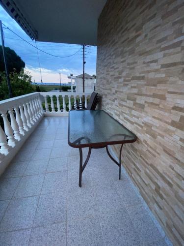 a bench sitting on a balcony with a brick wall at Evgenia's Apartment Sozopoli in Sozopoli