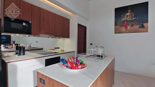 a kitchen with a counter with a bowl ofcolored pens at Santi Tara Villas in Amphoe Koh Samui