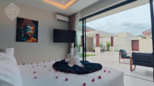 a bedroom with a bed with roses on it at Santi Tara Villas in Amphoe Koh Samui