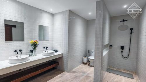 a bathroom with two sinks and a toilet at Santi Tara Villas in Amphoe Koh Samui