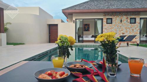 a table with a tray of food on a balcony at Santi Tara Villas in Amphoe Koh Samui
