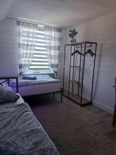 a bedroom with a bed and a window at Privatzimmer Gartenblick in Schnakenbek