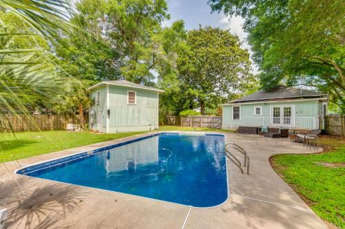a swimming pool in a yard with a house at Less Than 2 Mi to Dtwn Pensacola Peaceful Home with Patio in Pensacola