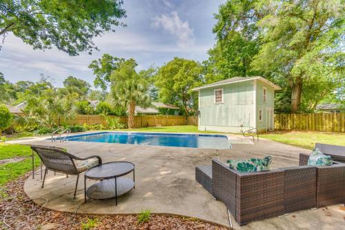a backyard with a pool and a tiny house at Less Than 2 Mi to Dtwn Pensacola Peaceful Home with Patio in Pensacola