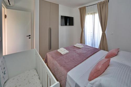 a small bedroom with two beds and a window at Apartment Ante in Bibinje