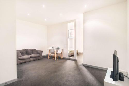 a living room with a couch and a table at Spacious 1 Bed Central Blackburn Apartment in Blackburn