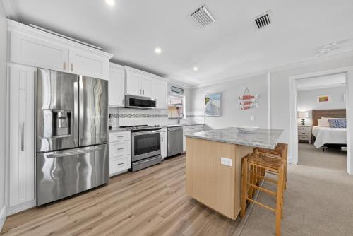 a kitchen with stainless steel appliances and white cabinets at Blind Pass A205 in Sanibel