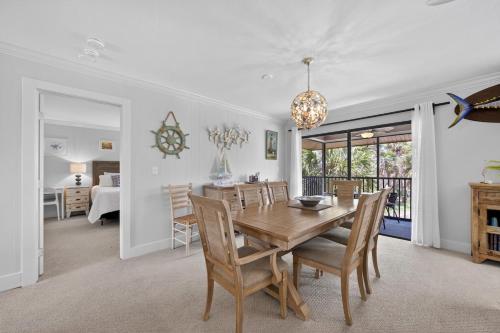 a dining room and living room with a table and chairs at Blind Pass A205 in Sanibel