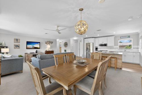 a dining room and living room with a wooden table at Blind Pass A205 in Sanibel