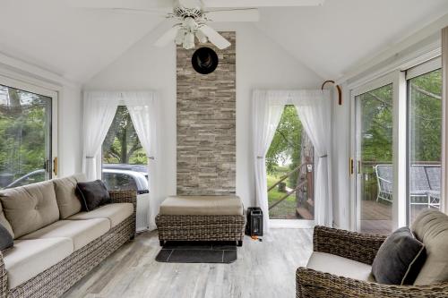 a living room with a couch and chairs and windows at Worcester Home on Indian Lake with Shared Boat Dock! in Worcester