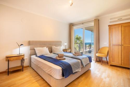 a bedroom with a bed with a view of the ocean at 426 Casa Onda Mirabaia in Albardeira