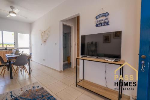 a living room with a large flat screen tv at Morski zakątek in Polis Chrysochous