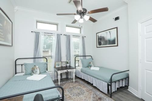 a bedroom with two beds and a ceiling fan at Private Backyard Oasis Spacious Home in Humble! in Houston