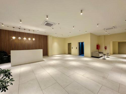 an empty room with a large room with a whiteboard at Tsikhisdziri Apt Sleeps 5 in Tsikhisdziri