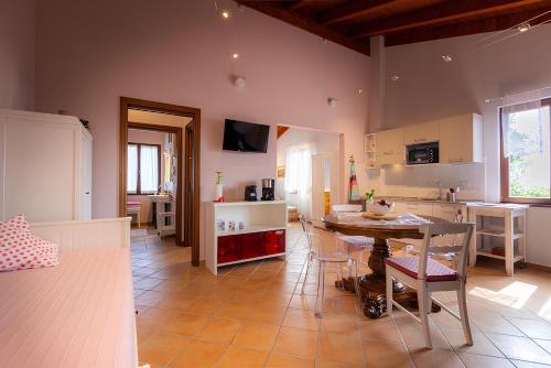 a kitchen and dining room with a table and chairs at Il Laghello Wood House in Framura