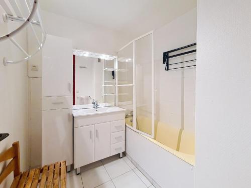 une salle de bain blanche avec un lavabo et une douche dans l'établissement Appartement lumineux au centre, balcon, proche pistes et commerces - FR-1-344-946, aux Menuires