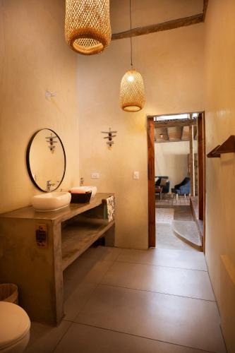a bathroom with a sink and a mirror at Casas La Floristería in Palomino