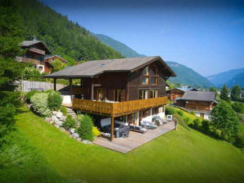 a large house on a hill with a green lawn at Chalet Isla de Lux - OVO Network in La Côte dʼArbroz