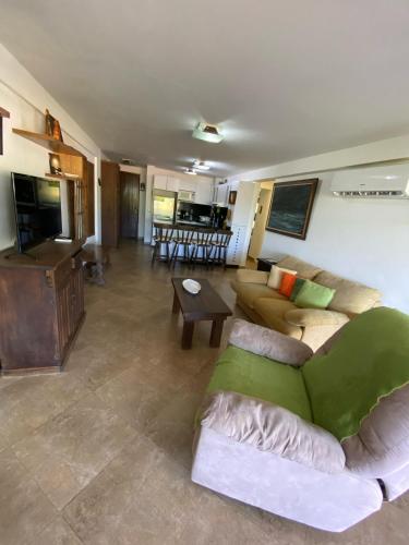a living room with a couch and a table at Playa Guacuco - Views and Beach Access in Playa Guacuco
