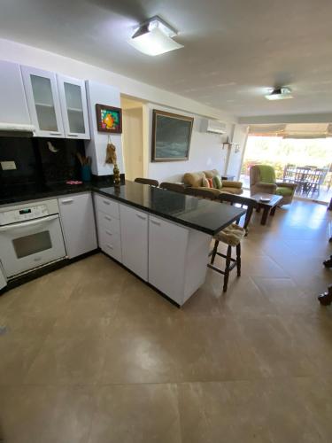a kitchen and living room with a table and a couch at Playa Guacuco - Views and Beach Access in Playa Guacuco