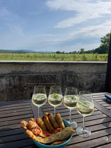 a plate of food and wine glasses on a table at Agriturismo La Segolina in Colle Val D'Elsa