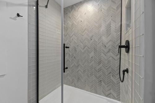 a shower with a glass door in a bathroom at Tranquility Point in Lac du Flambeau WI in Lac du Flambeau