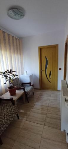 a living room with a door and a table and chairs at Casa Ella in Tuzla