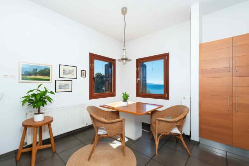 a dining room with a wooden table and chairs at Sea & Salt ,Pelion,Agria Volos in Agria