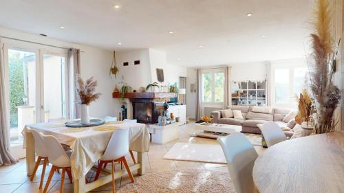 un salon avec une table et un canapé dans l'établissement Spacieuse villa Les Alizées, à Montélimar