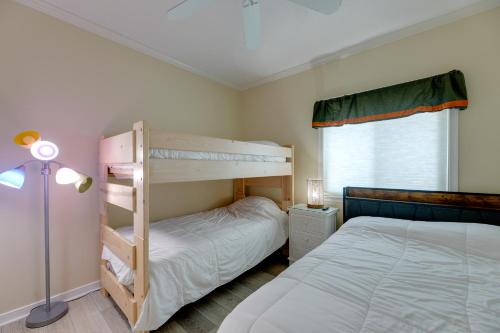 a bedroom with two bunk beds and a window at Steps to Beach Ocean City Getaway with Pool Access! in Ocean City