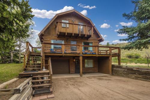 a large wooden house with a balcony on top at River Gem in Creede