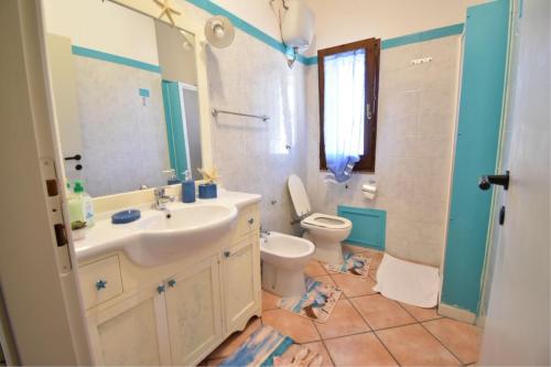 a bathroom with a sink and a toilet at Villa Venere in Domus de Maria
