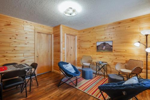 a room with wooden walls and chairs and a table at River Gem in Creede