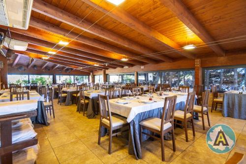 a dining room with tables and chairs and windows at L'isola felice in Silvi Marina