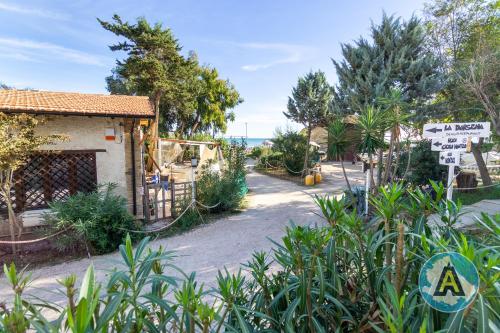 a house with a sign in front of a street at L'isola felice in Silvi Marina