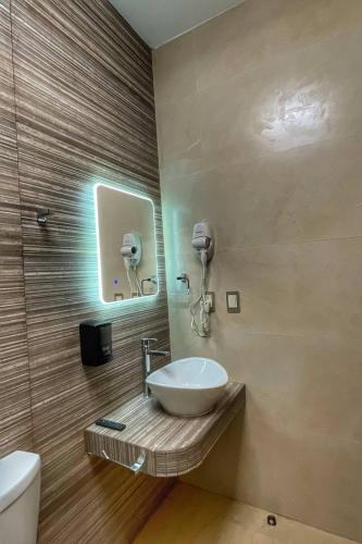 a bathroom with a sink and a phone on the wall at Casa Bonita PXM in Puerto Escondido