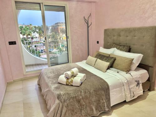 a bedroom with a large bed and a large window at Spacious family accommodation in Rabat