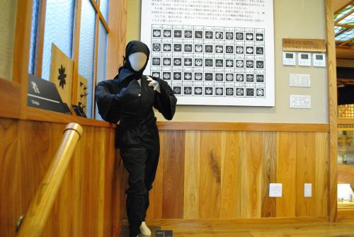 a person in a costume standing at a counter at Hotel Kazahaya in Hita