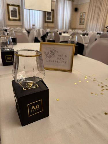 a wine glass on a table in a room at Thomas Arms Hotel in Llanelli